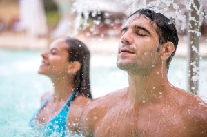 Couple relaxing under a stream of water