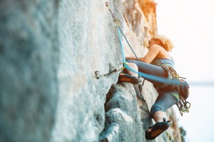 Rock climbing on vertical flat wall - Stock image